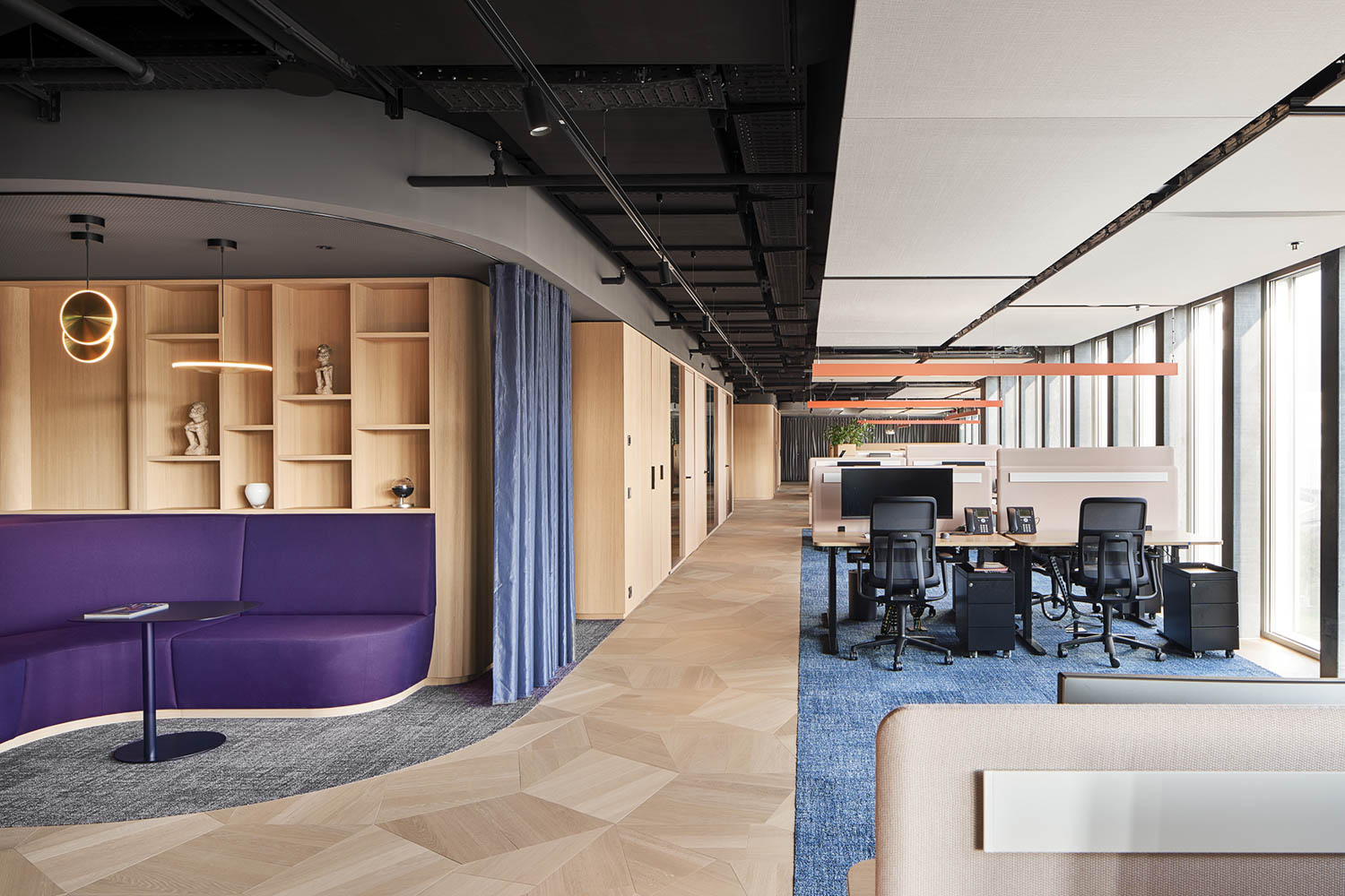 work space with lots of light, wooden shelves and purple booth