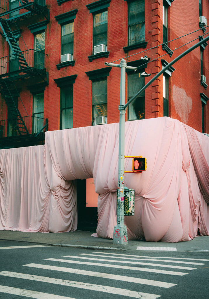 pink drapes cover a New York City building