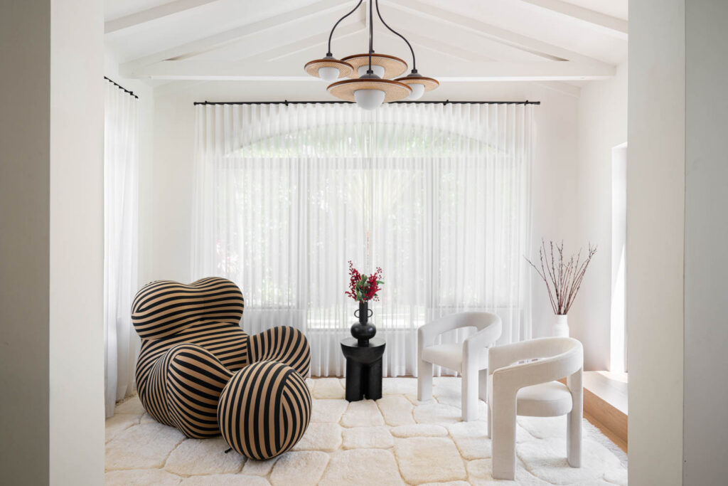 lounge area with white chair, chandelier and rounded ball chair