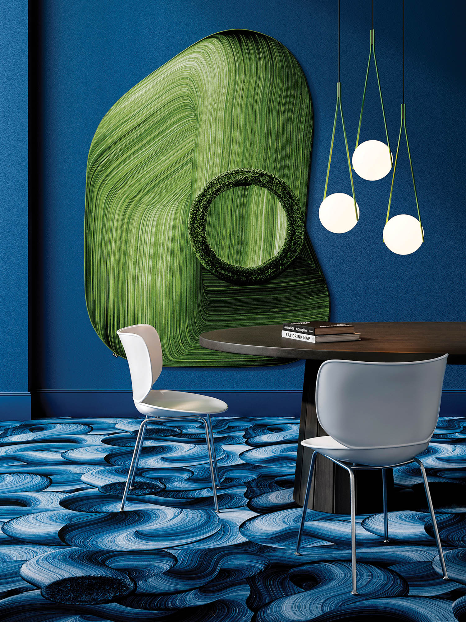 room with blue walls, abstract green artwork and table
