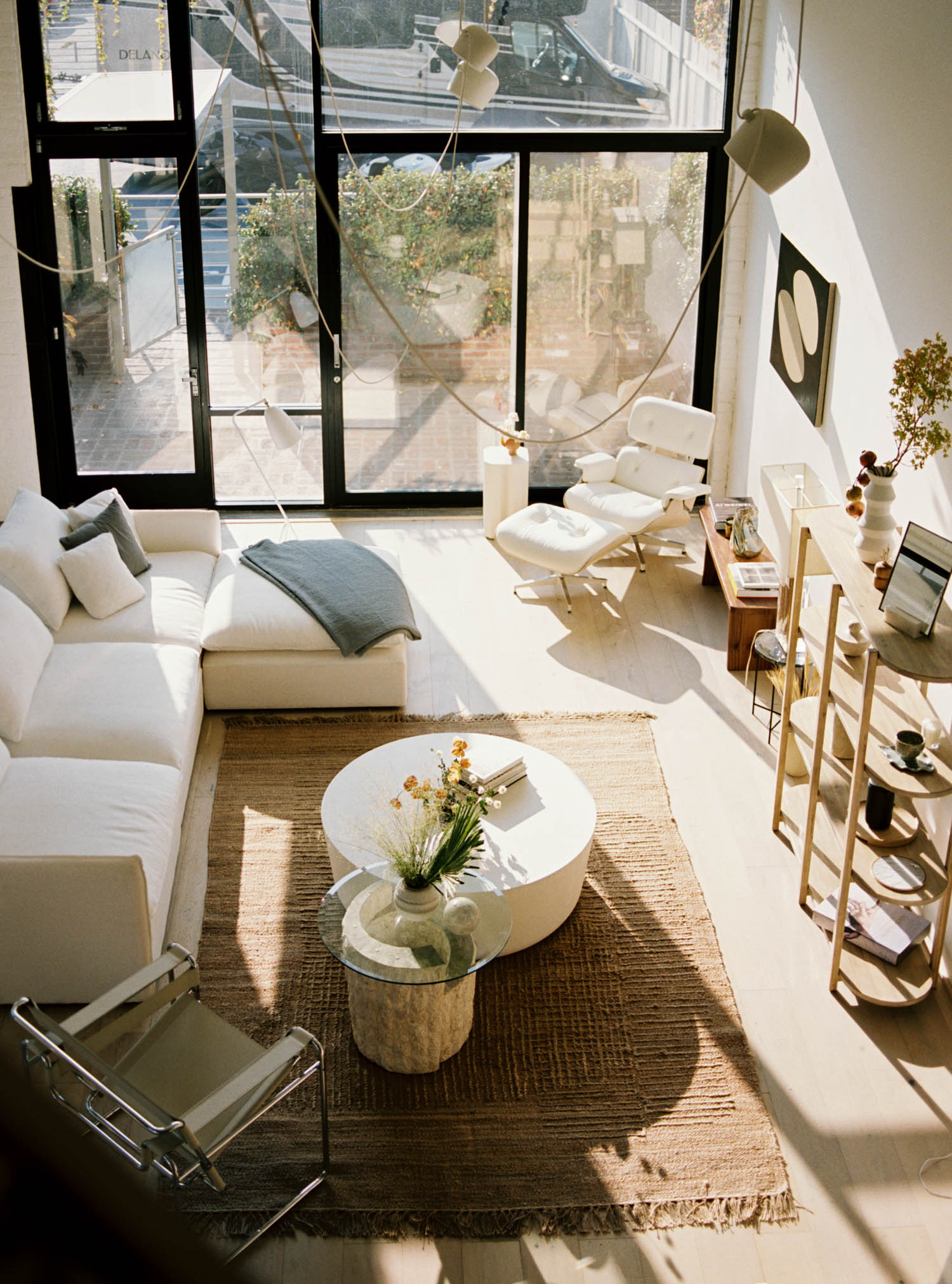 a sunlit living room with white sectional