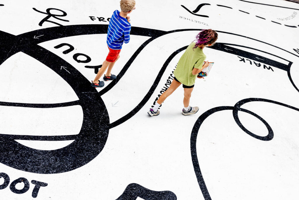 two children walking through the installation