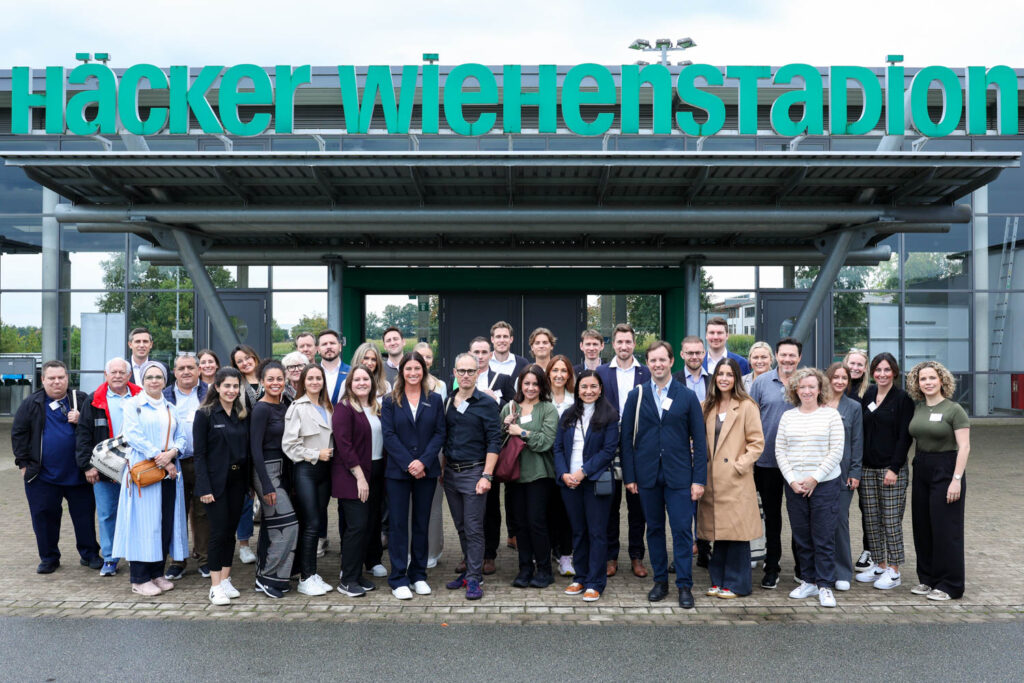 everyone who joined Hacker's factory tour stands outside the factory