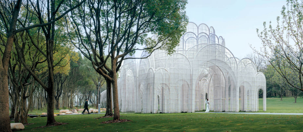 large white pergola building surrounded by trees