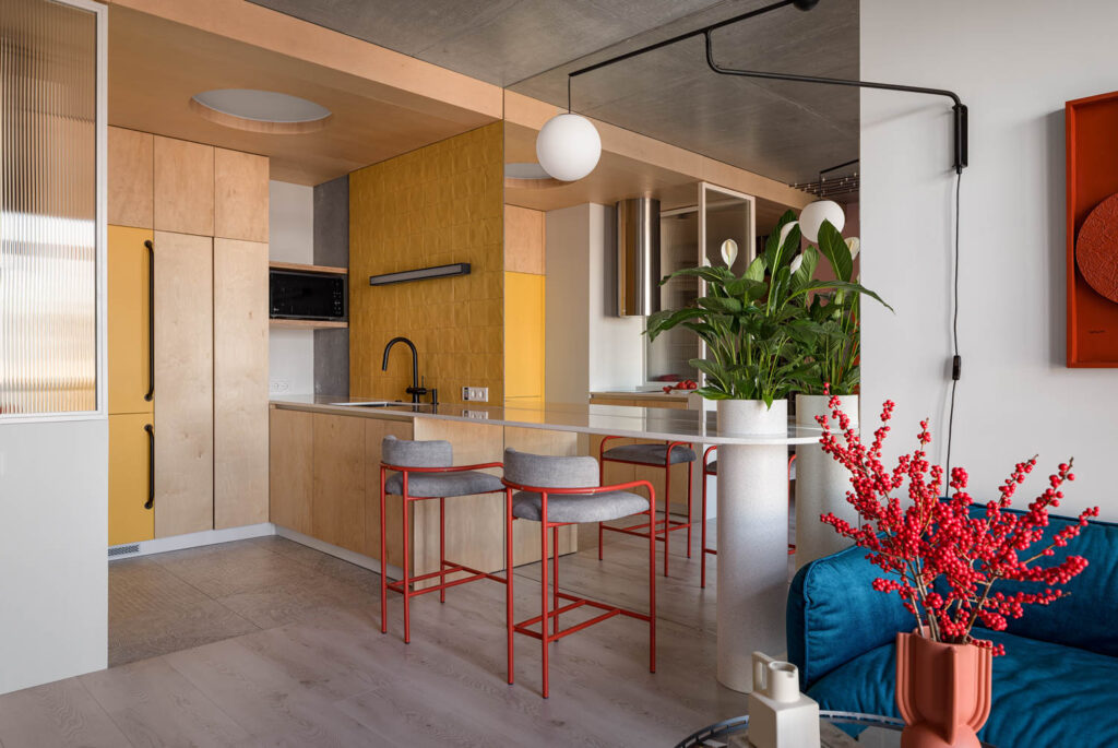 kitchen with yellow wall tiles, wooden cabinets and large mirror