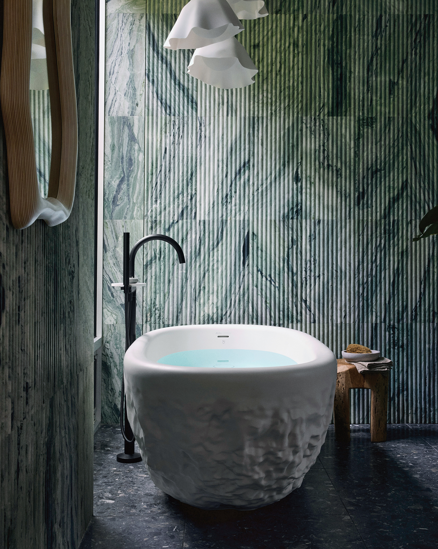 A bathroom with a large white tub and a wooden wall