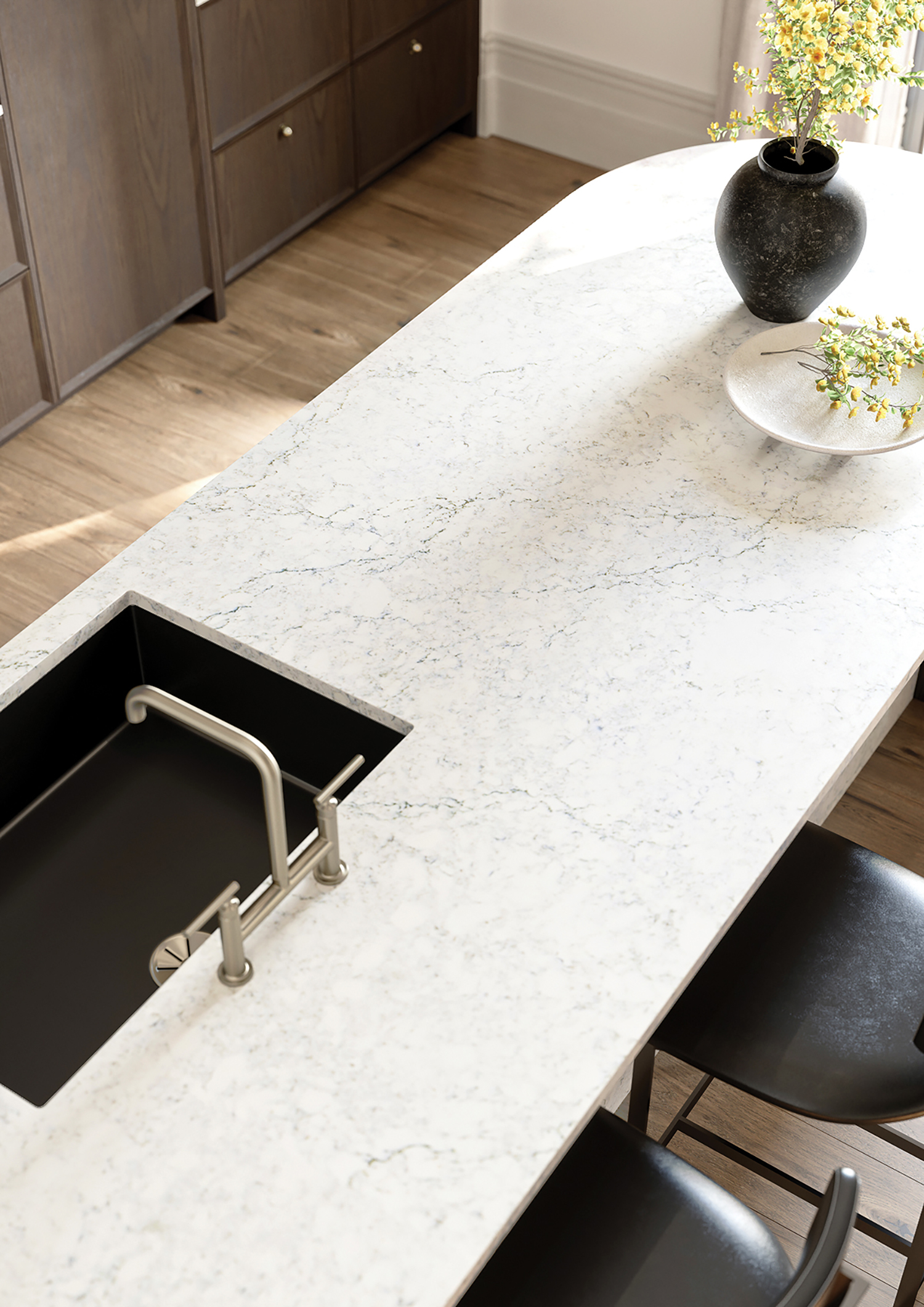 a white marble kitchen island with a black sink