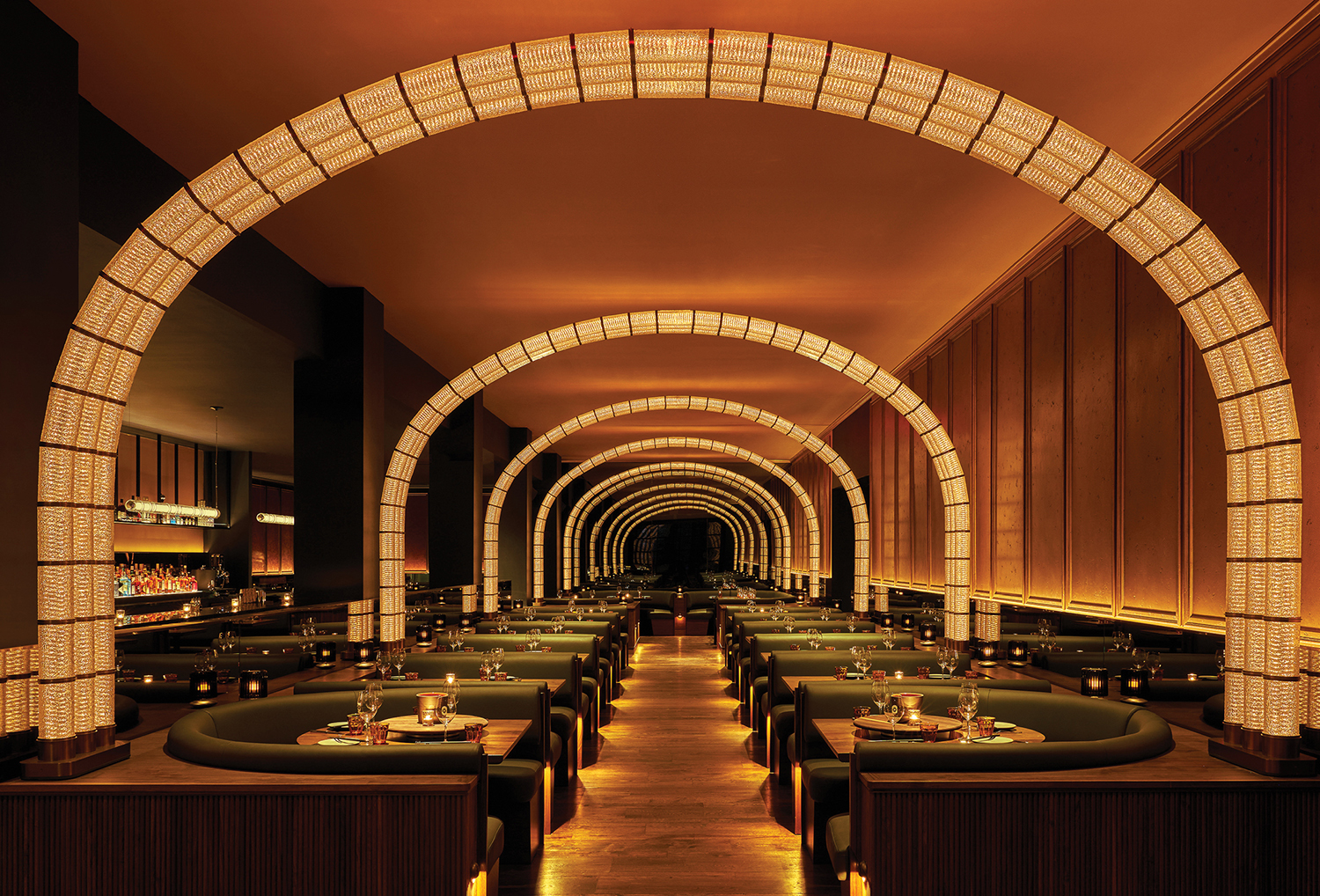 A restaurant with a long table and a circular archway