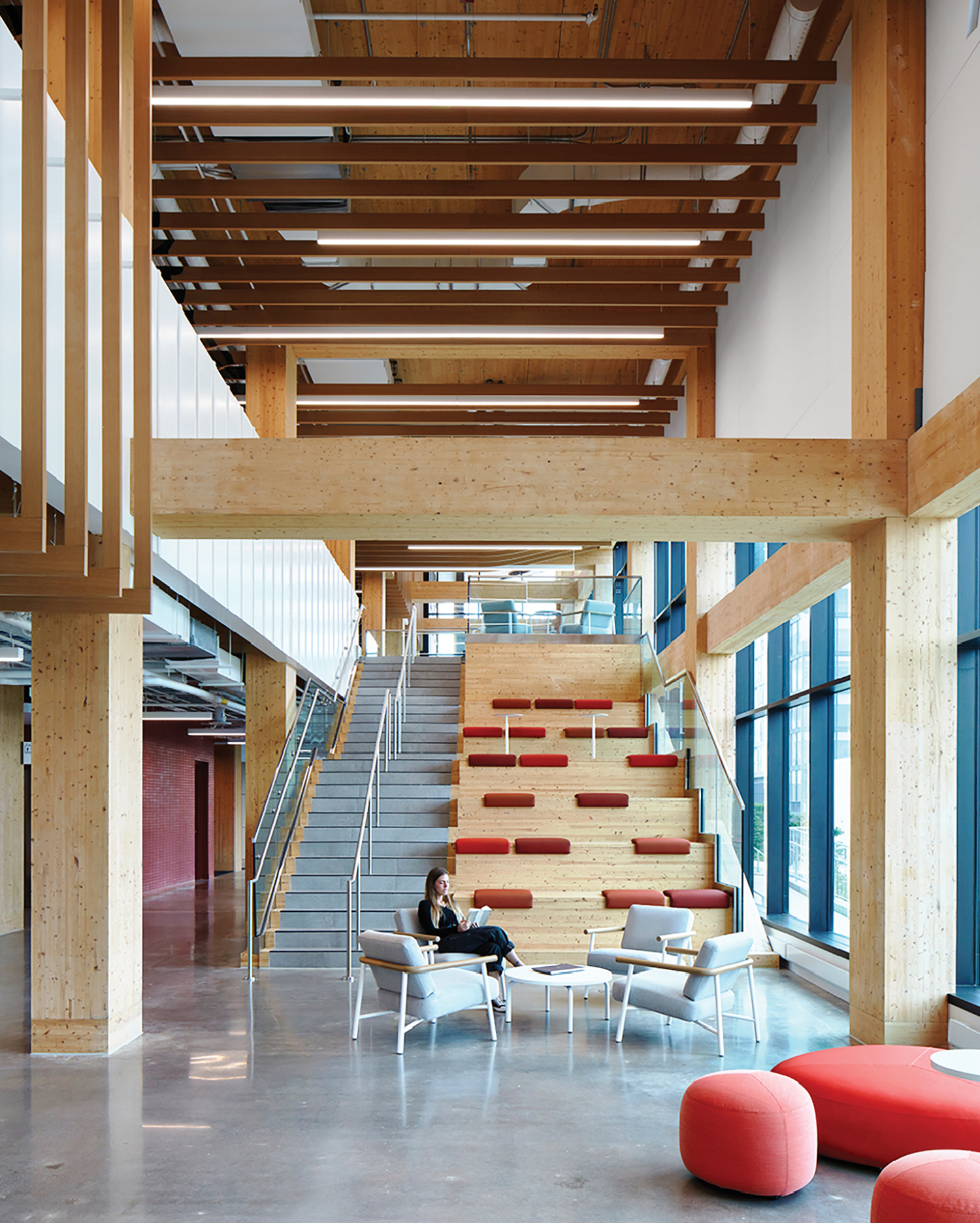 A large open space with a staircase and a red couch