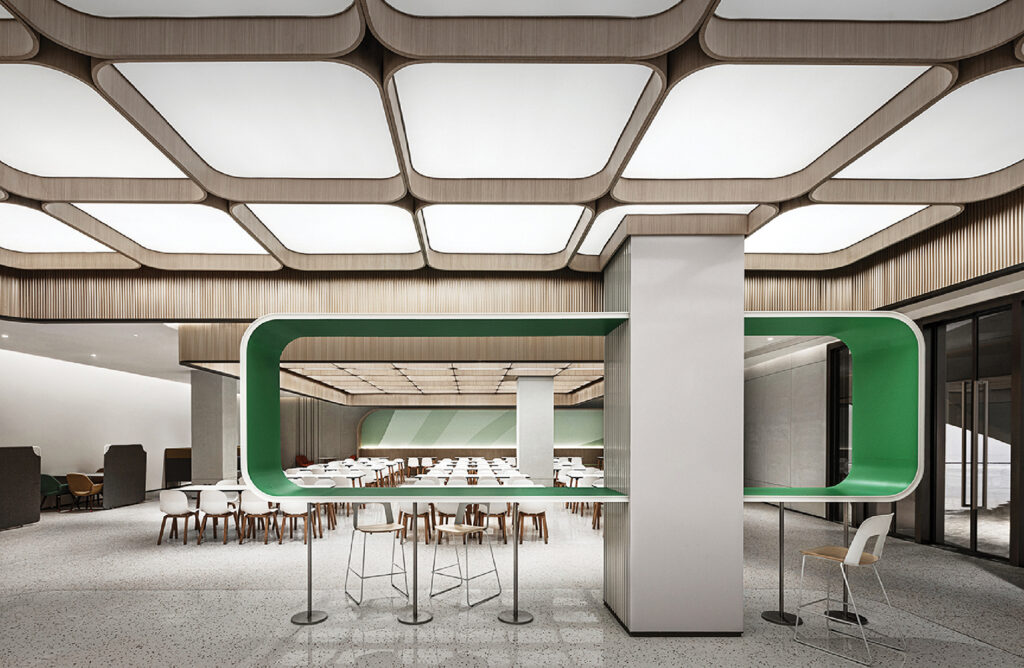 a room with a table and chairs and a green wall