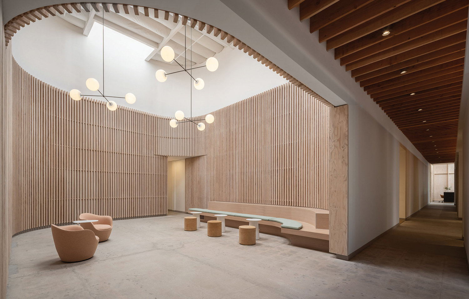 a large room with a wooden ceiling and a bench