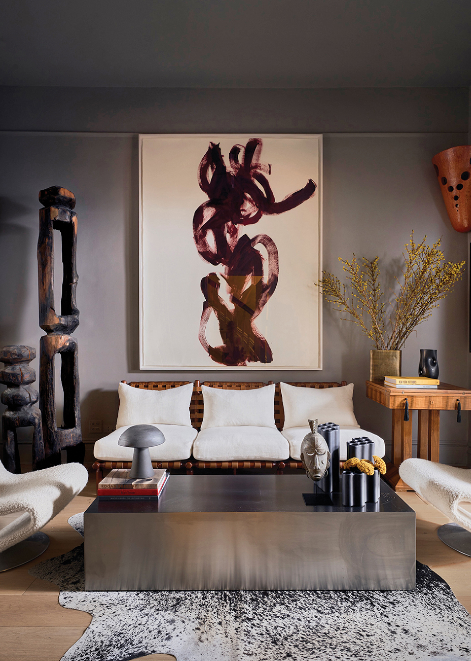a living room with a large painting on the wall