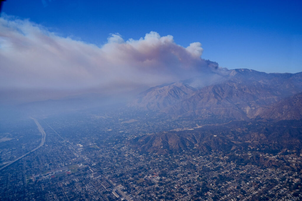 a plume of smoke rises from the LA city basin