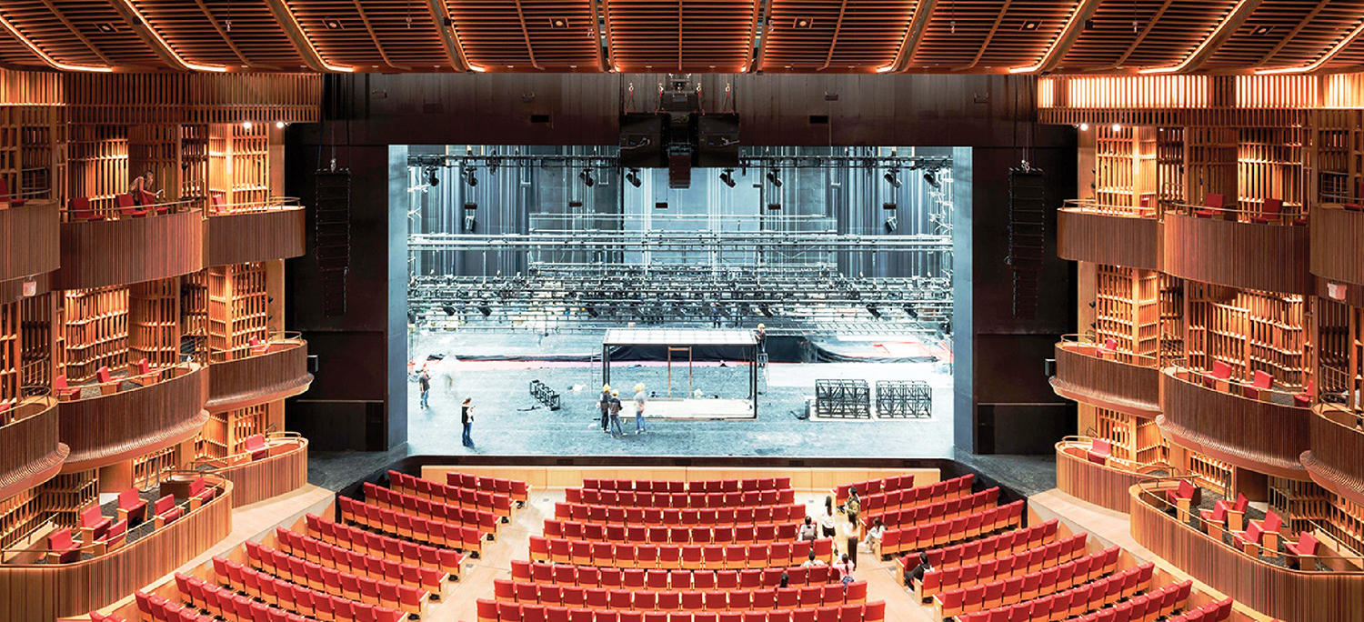 A large auditorium with rows of seats and a stage