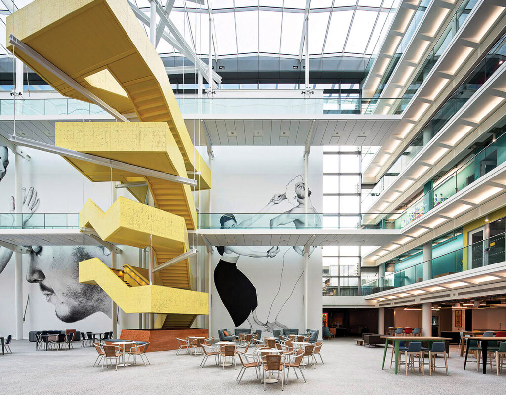 The interior of the new library building, with a staircase and a table