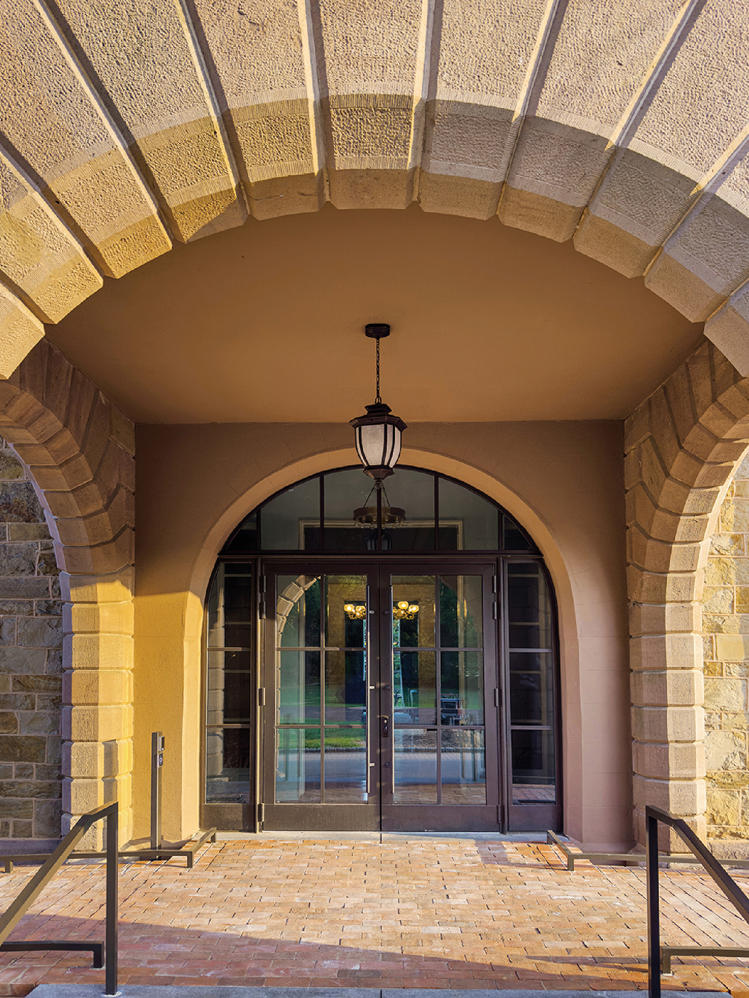 A large stone building with a door and a light