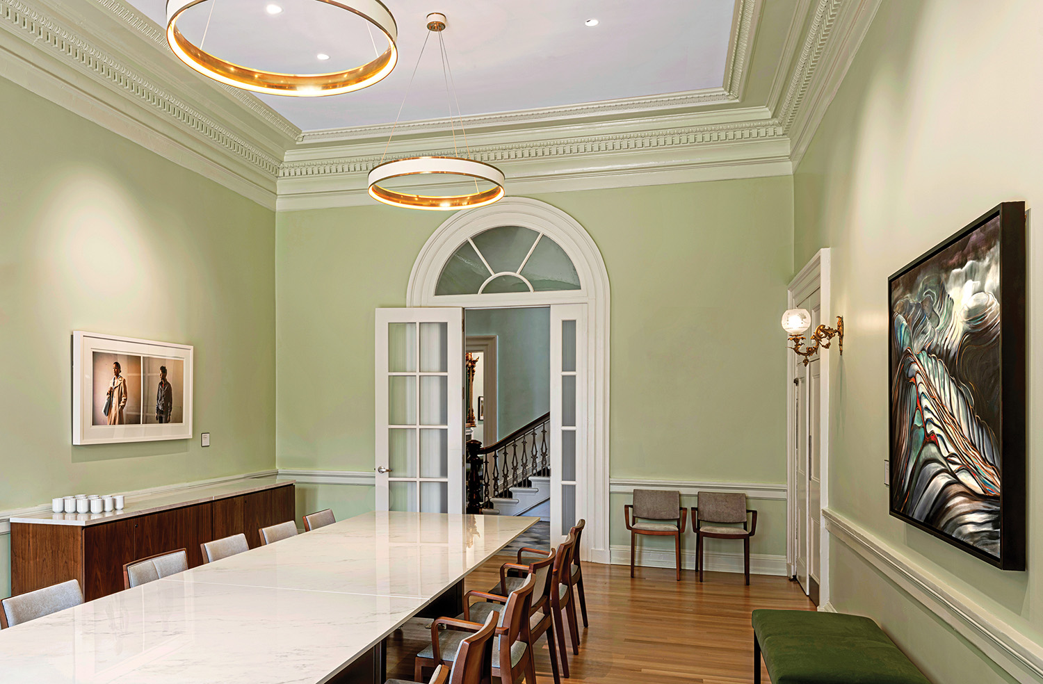 A dining room with a large table and chairs