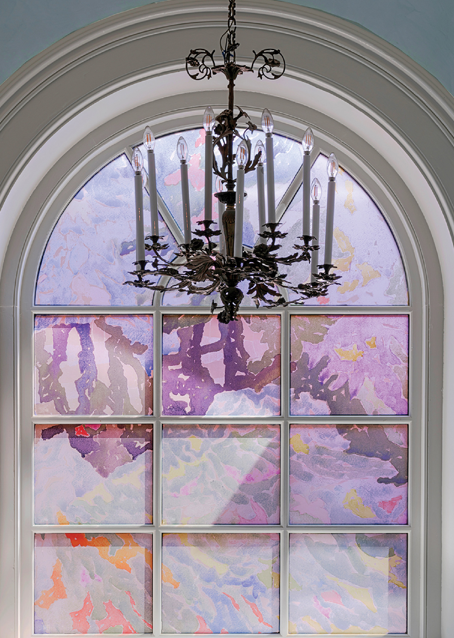 A chandel hanging in a window
