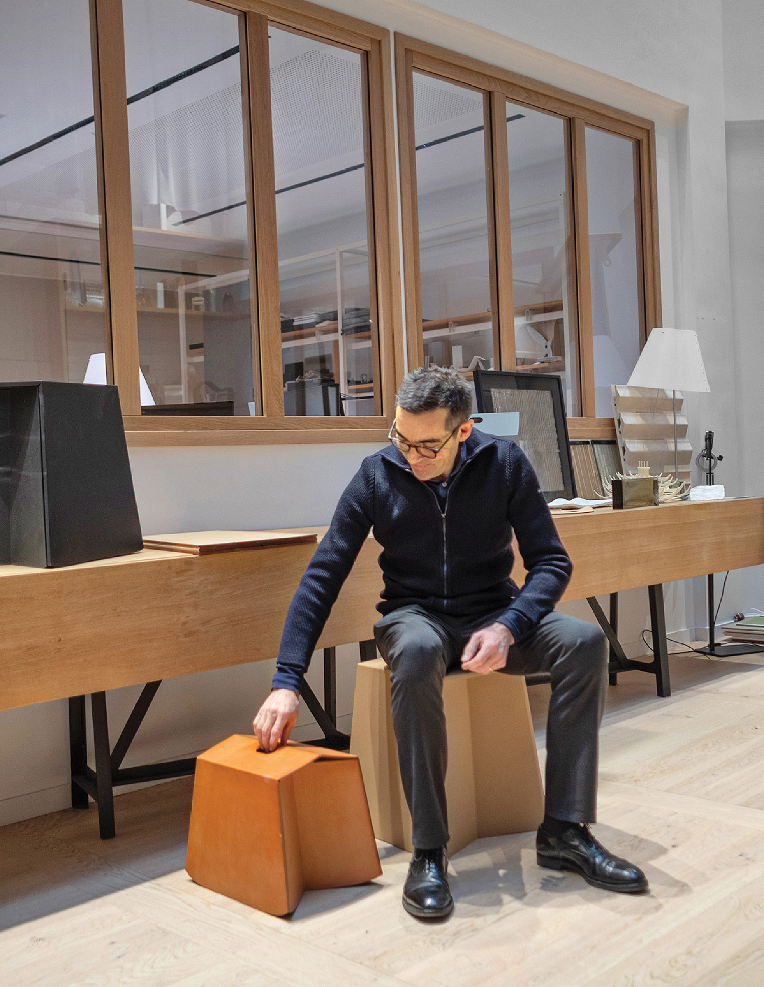 A man sitting on a box in a room