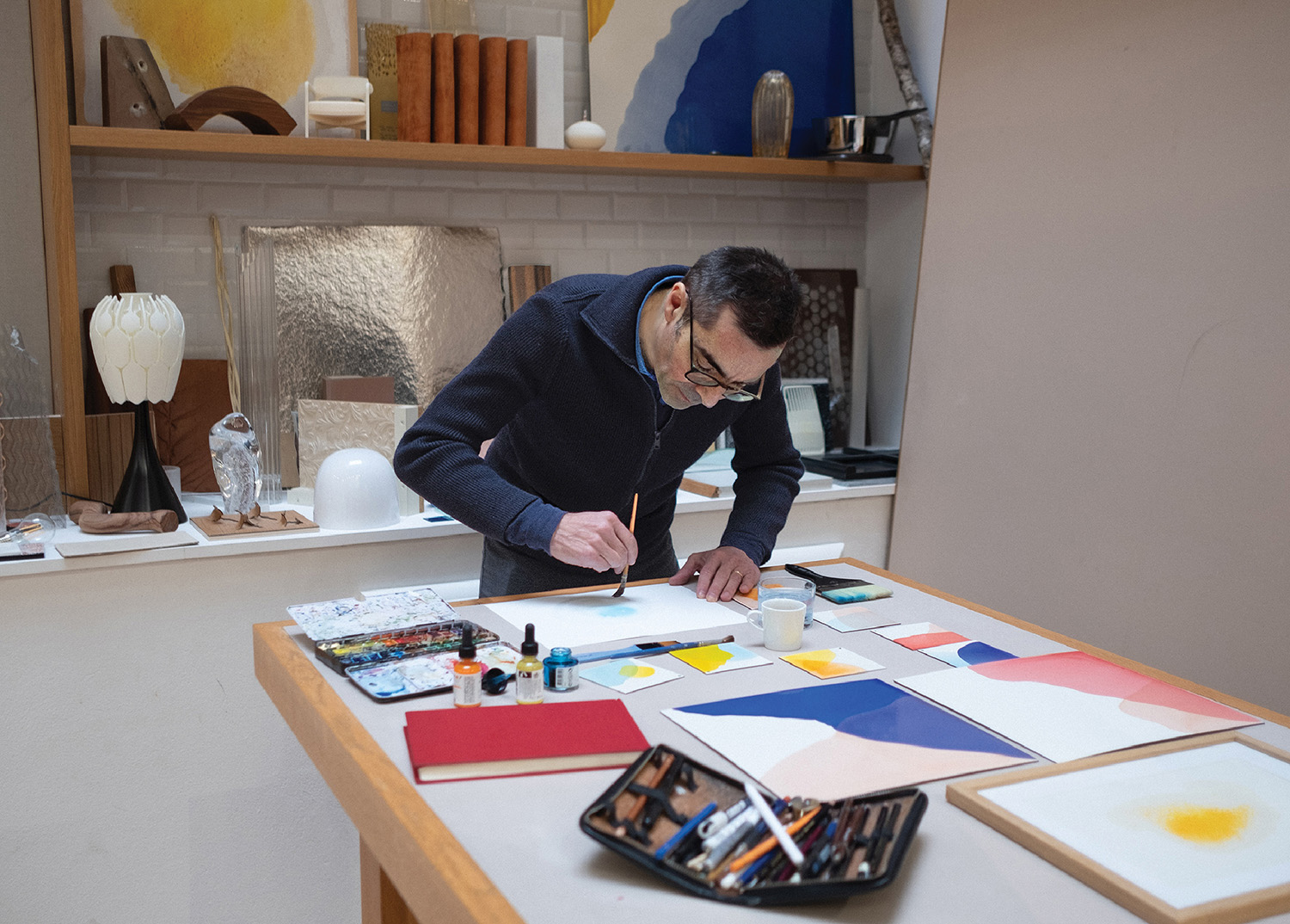 A man is painting on a table