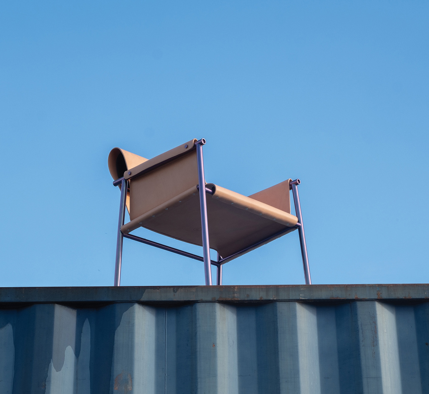 A chair sitting on top of a metal container