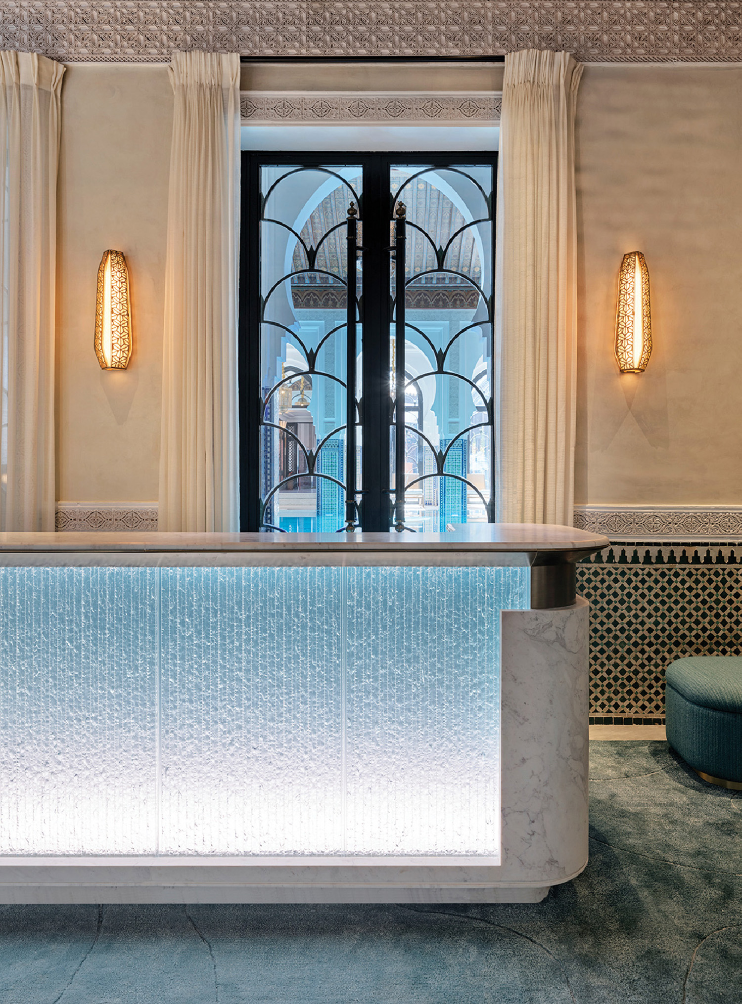 A white marble reception table with a blue and white marble coun