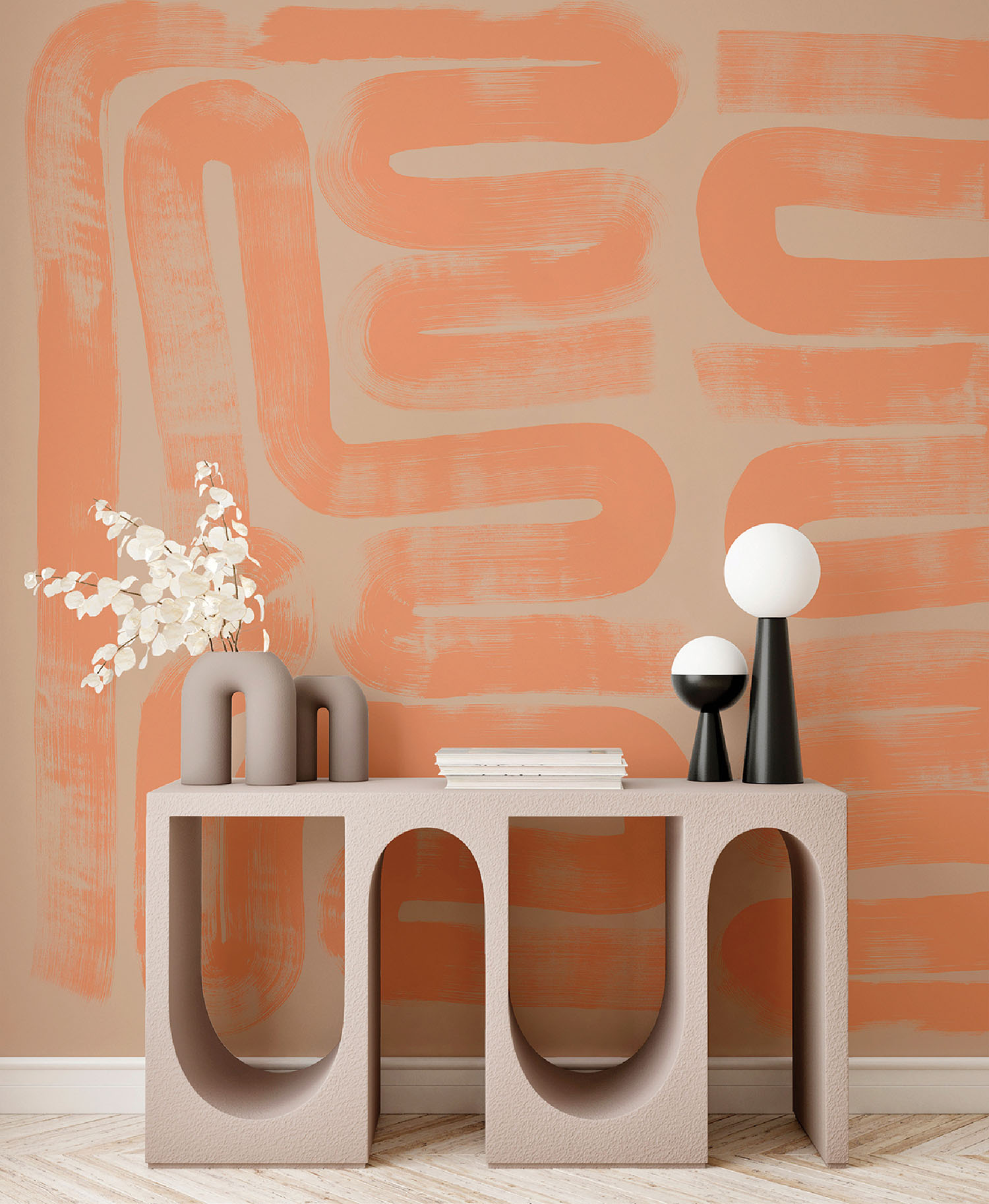 A vase and lamp on a table in front of a wall with a painted ora