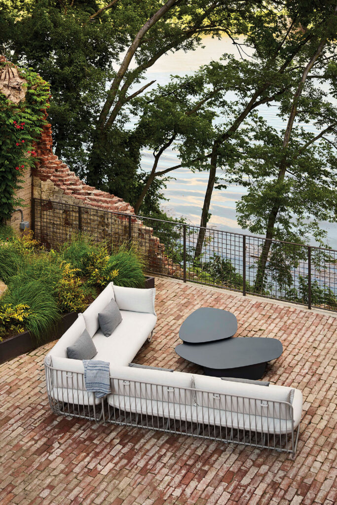 A white couch sitting on top of a brick patio