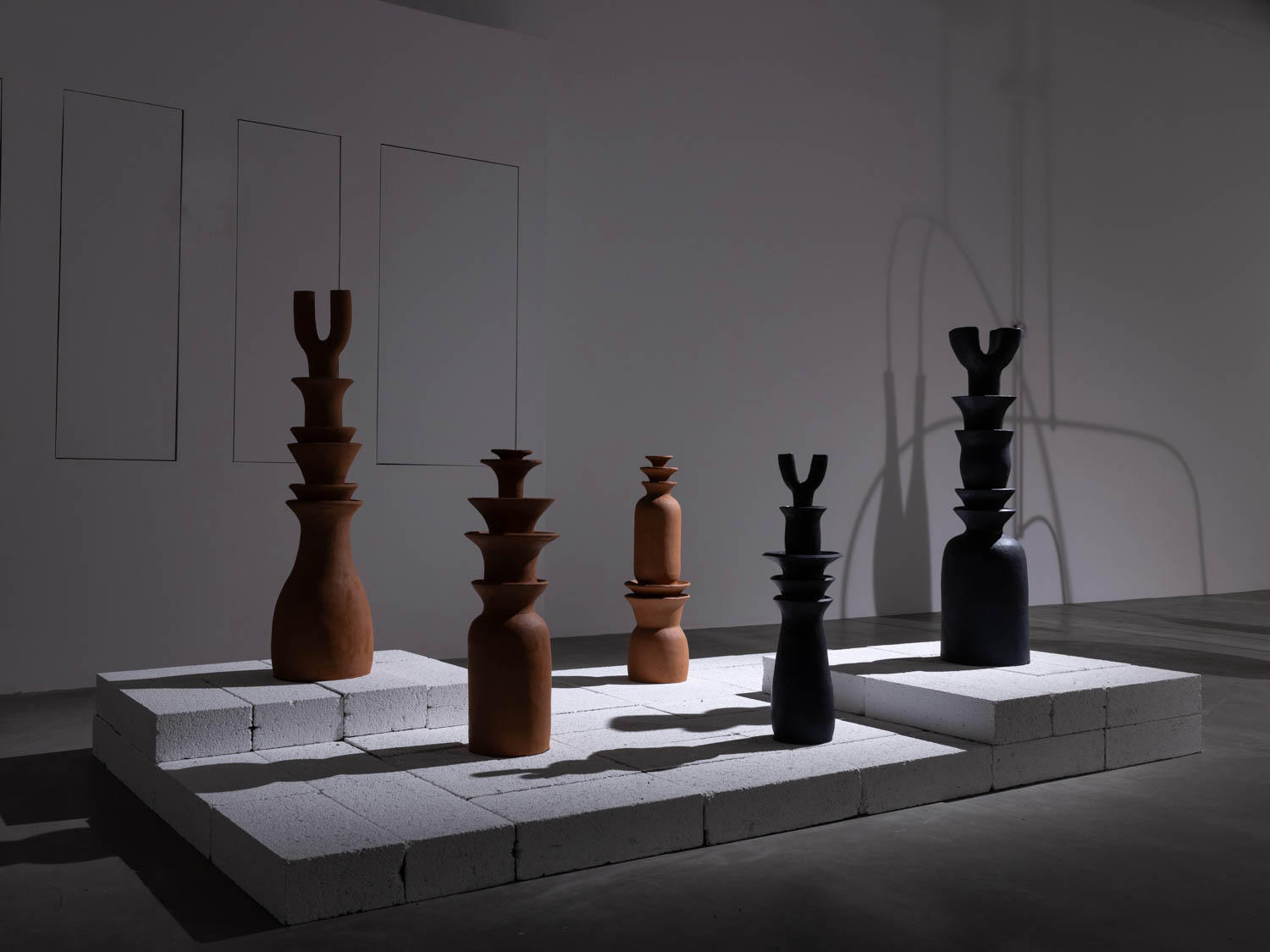 five chess pieces all standing in a row