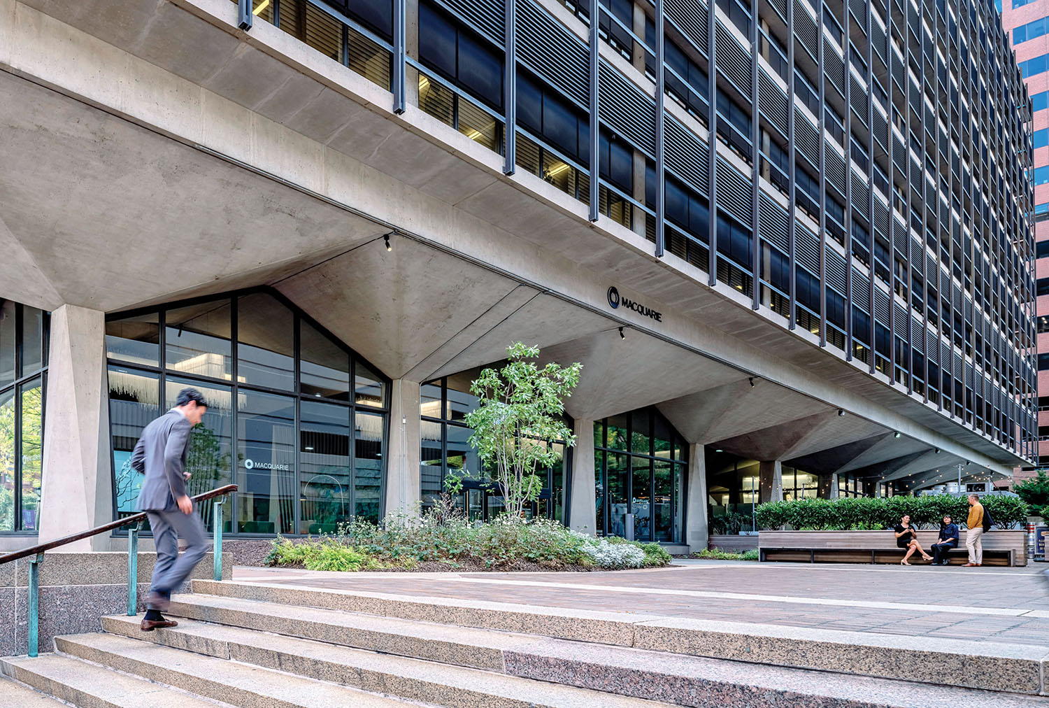 A man is walking up some steps in a city