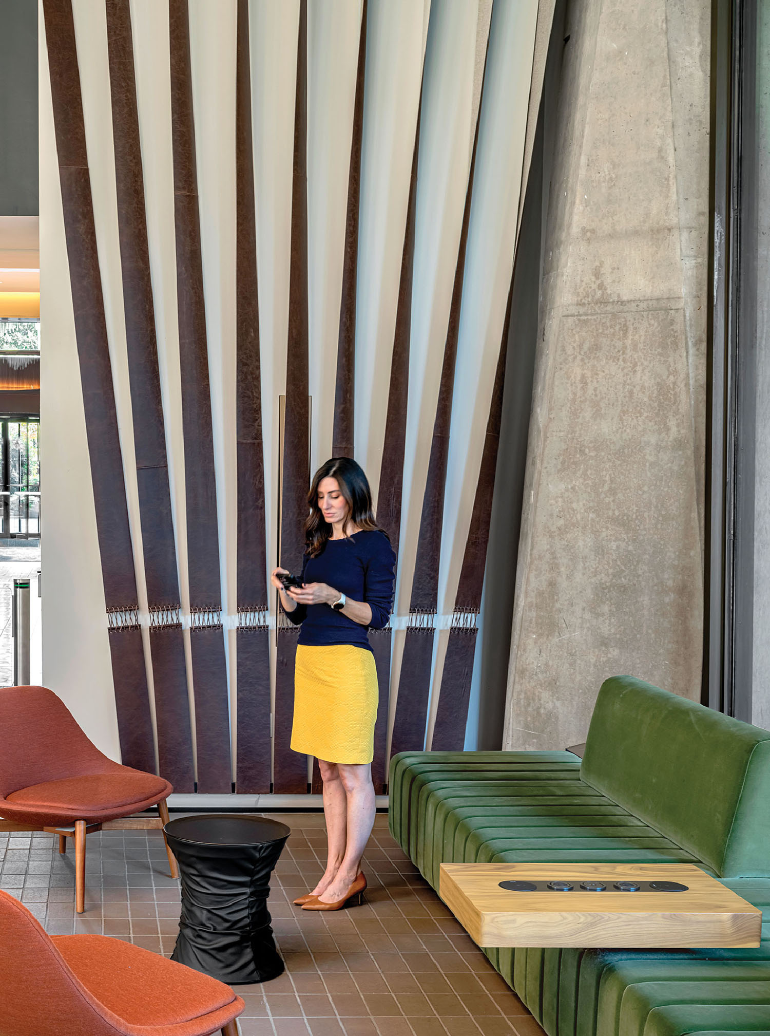 A woman standing in a room with a green couch