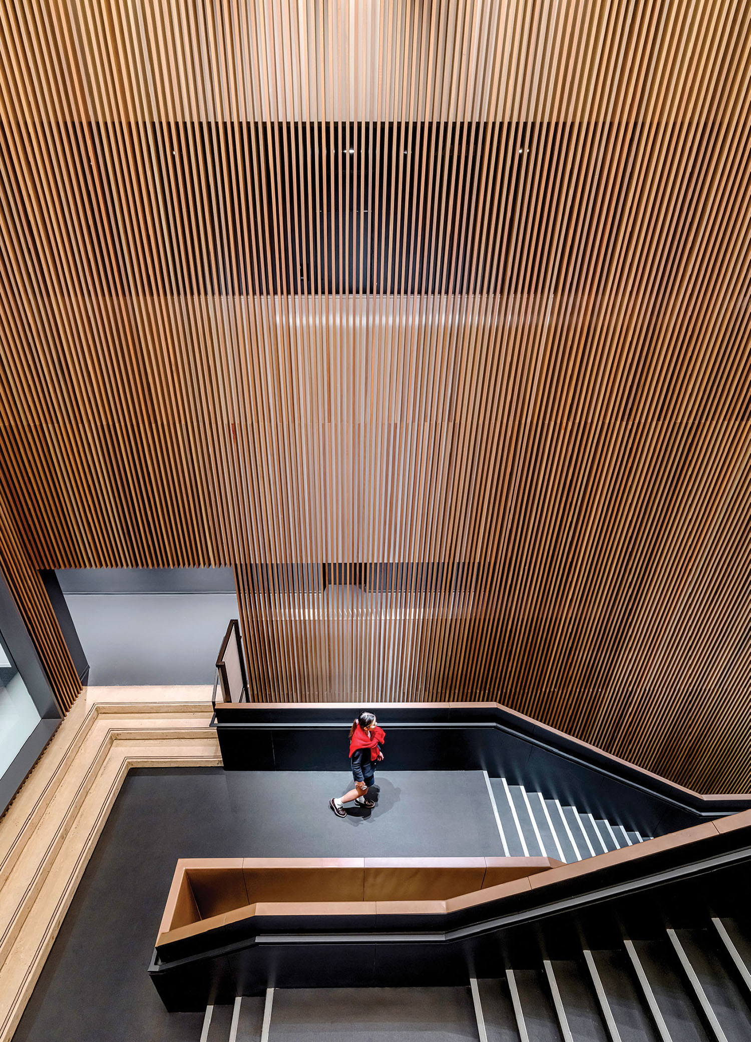 A person is sitting on a bench in a room