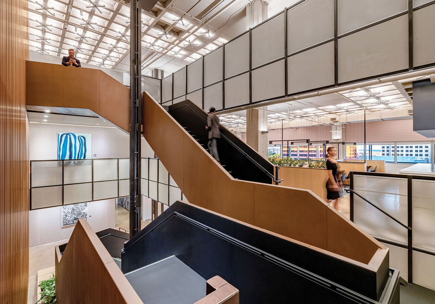 A staircase in a building with a person walking up it
