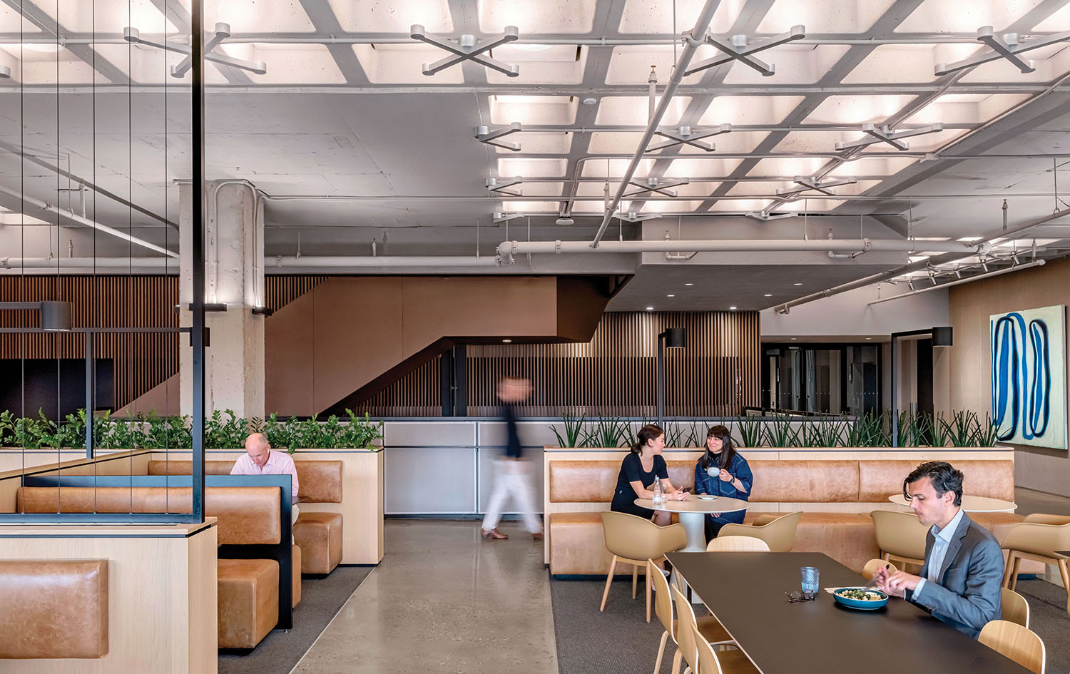 A couple of people sitting at a table in a large office