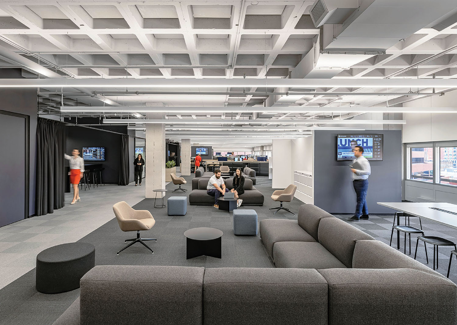 The office by Rapt Studio features a large open space with a large couch