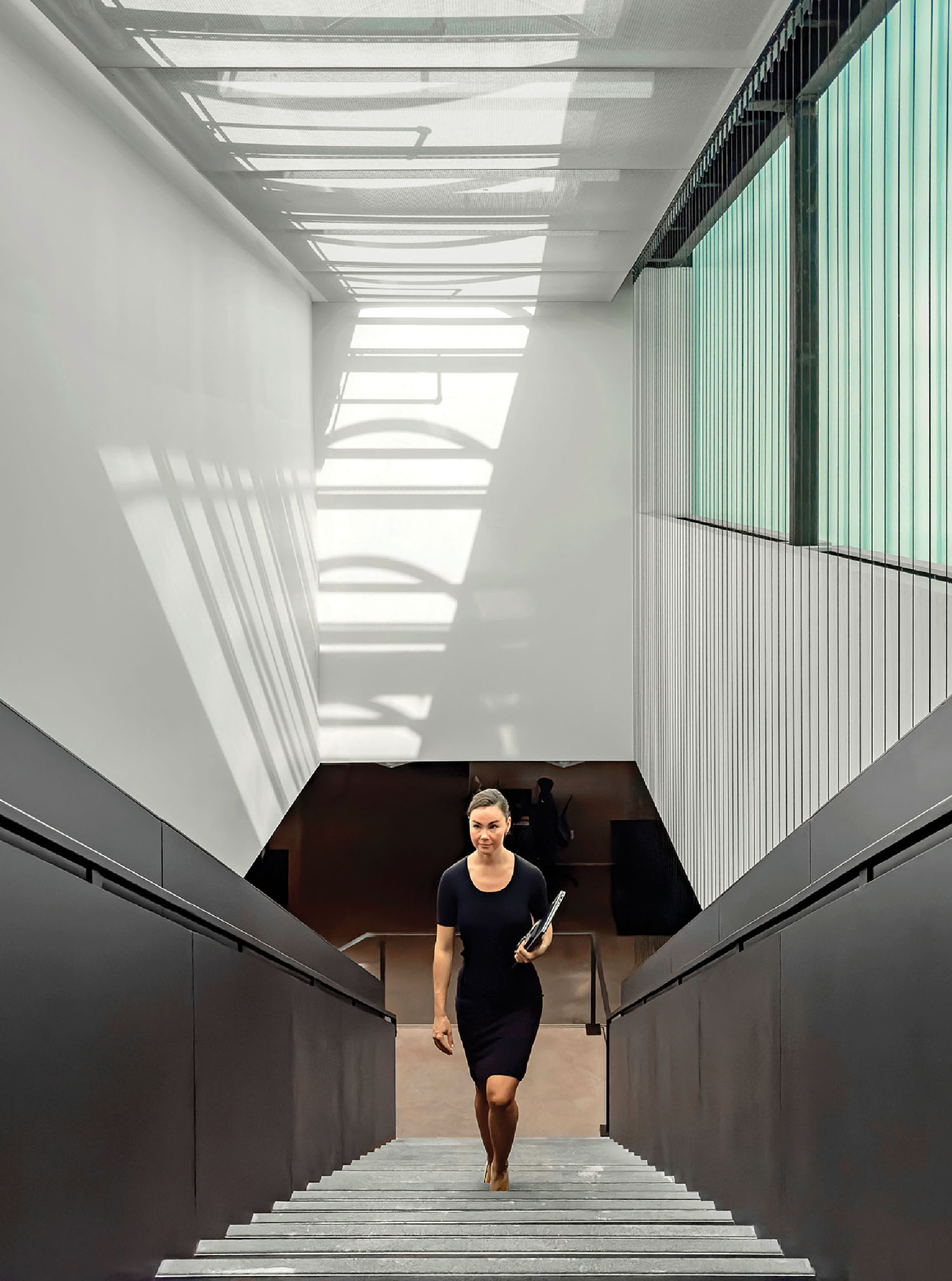 A woman walking down the stairs in a building