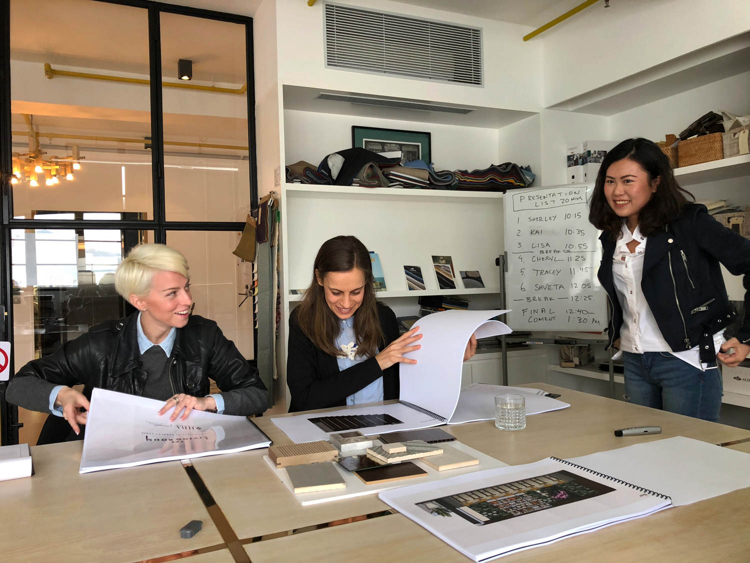 three people sitting at conference table
