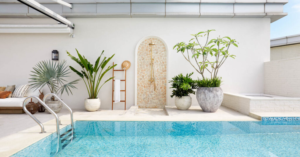 pool area of penthouse with shrubbery and arched doorway