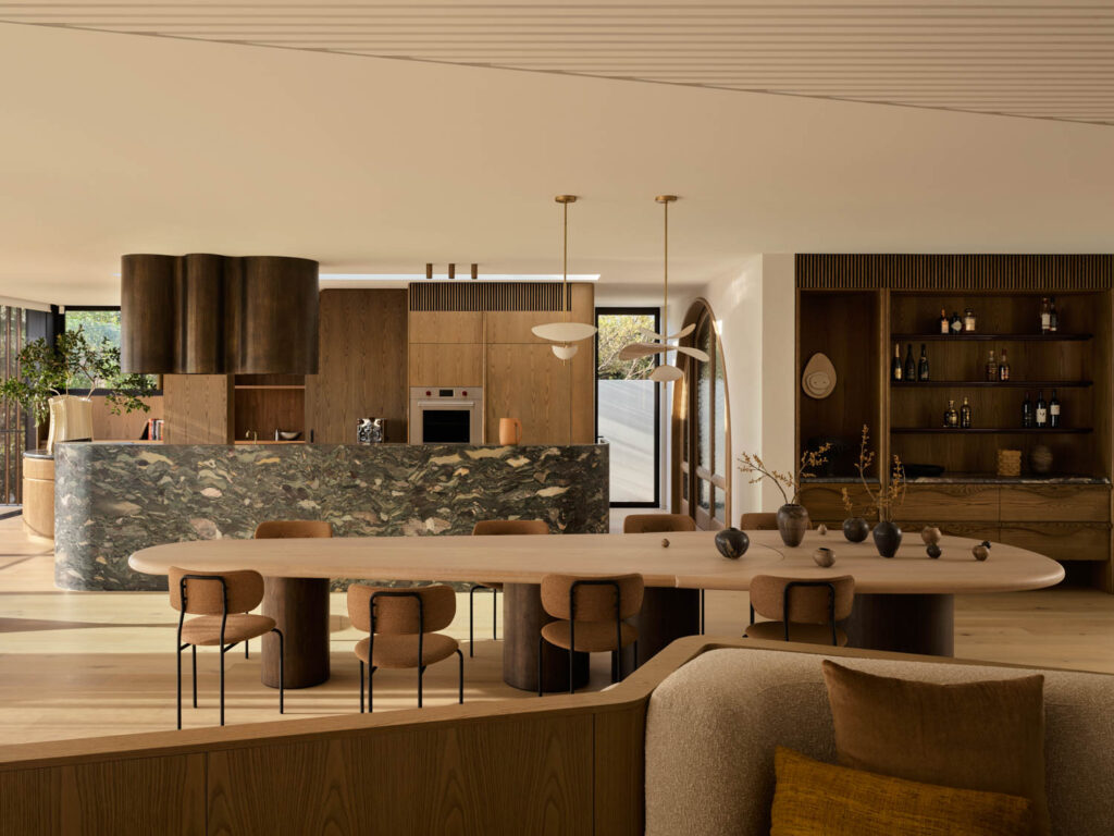 kitchen area with long dining table, kitchen and natural lighting