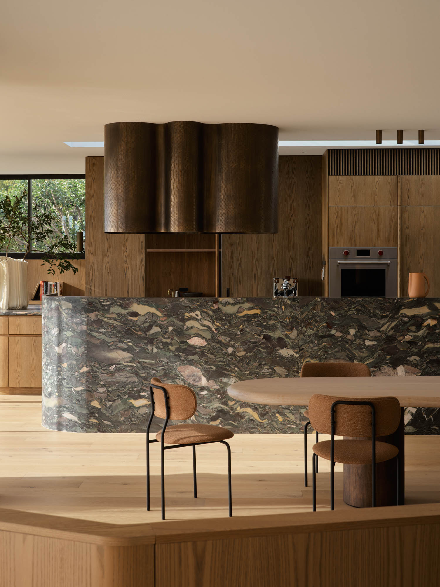 kitchen with dark marble island and neutral hues
