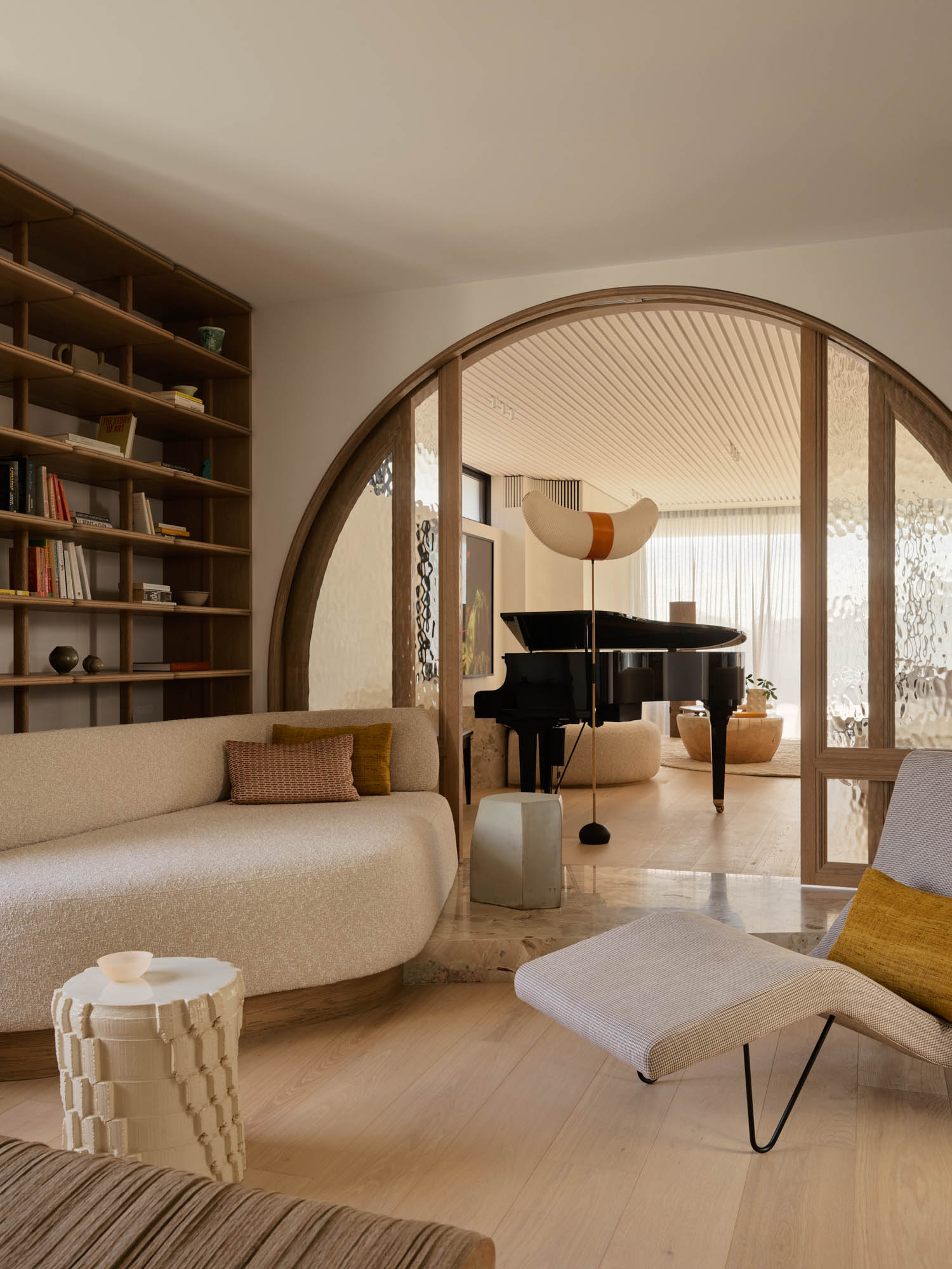 library area with arched entryway, shelves and seating
