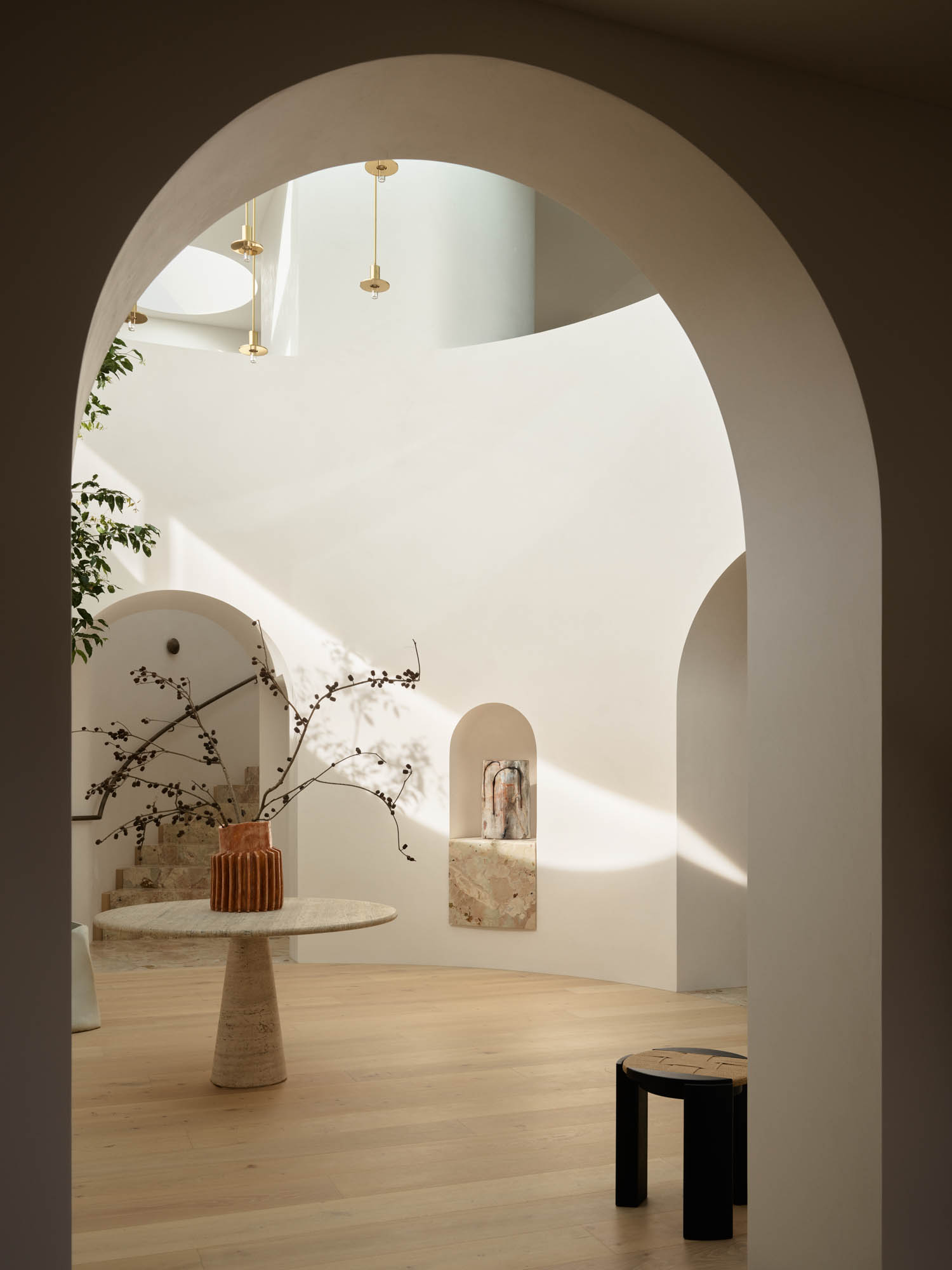 entryway with arched entrance and view of stairs