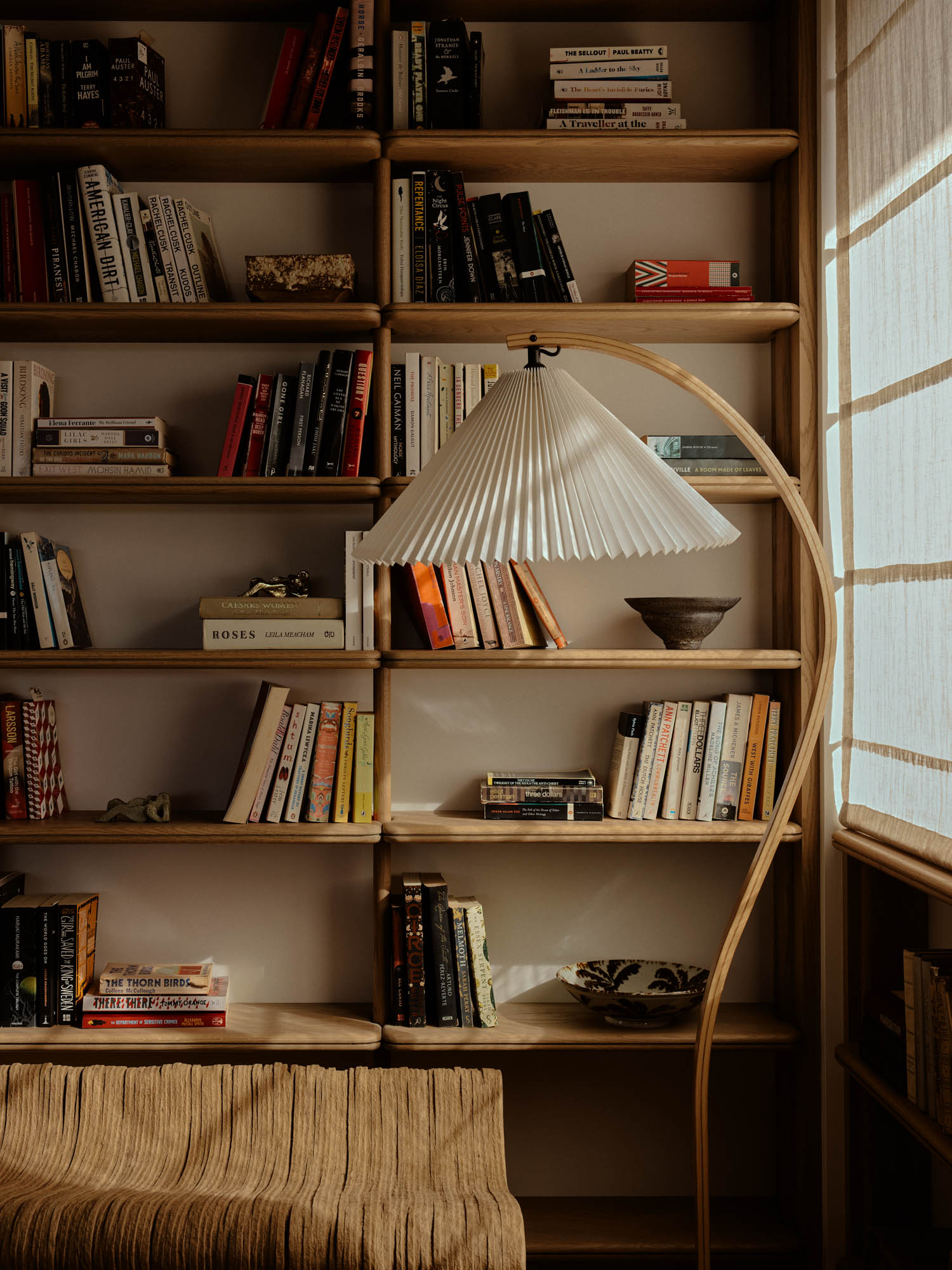 library area with shelves, lamp and seating