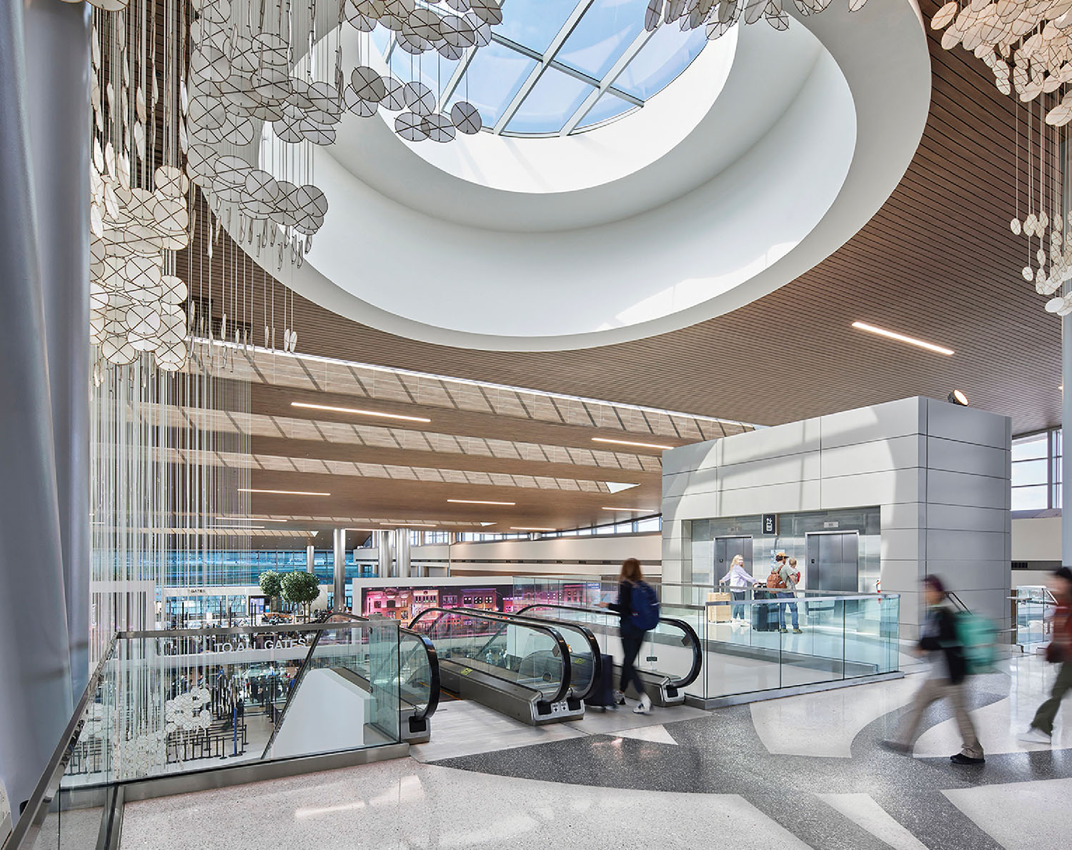 A large atrium with a glass ceiling and a staircase.