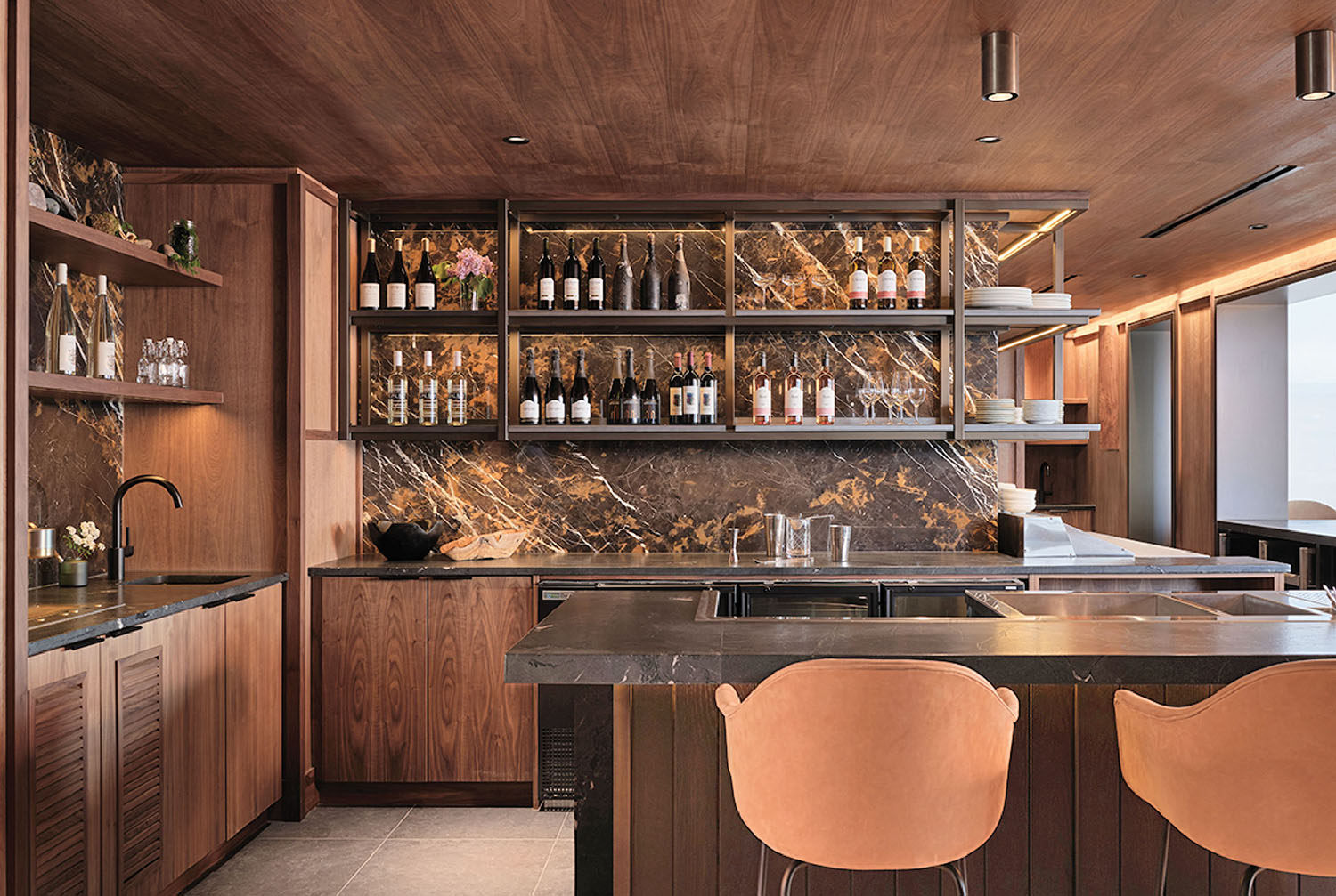 A kitchen with a marble counter top and a bar