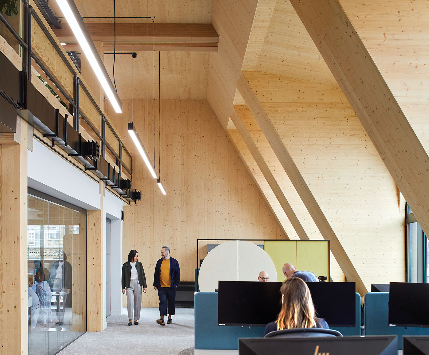 A group of people are working in a large office