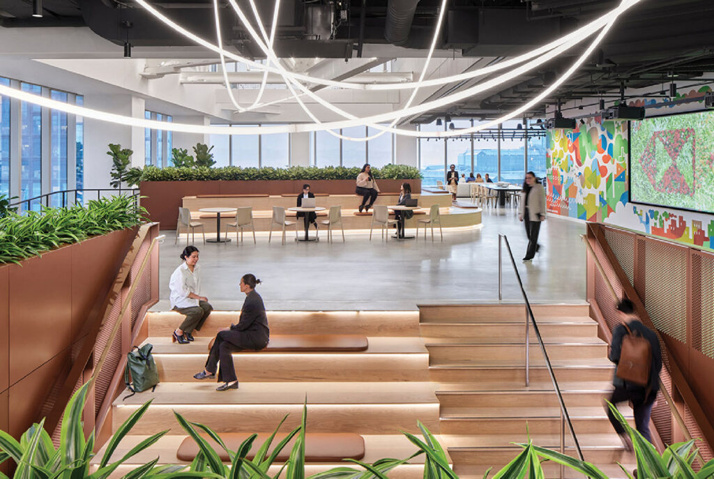A group of people sitting on the stairs of a building.