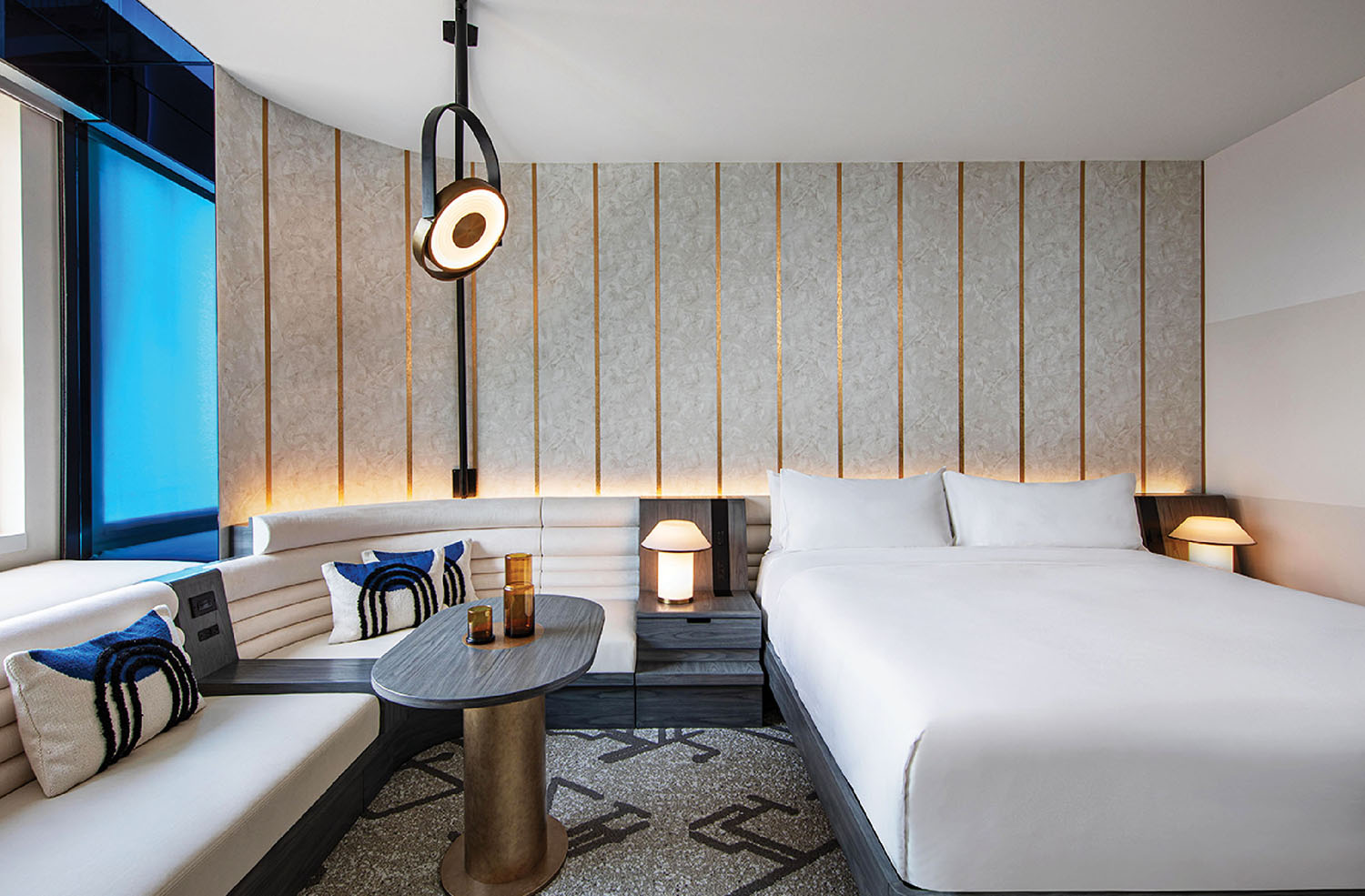 A bed sitting next to a couch in a room