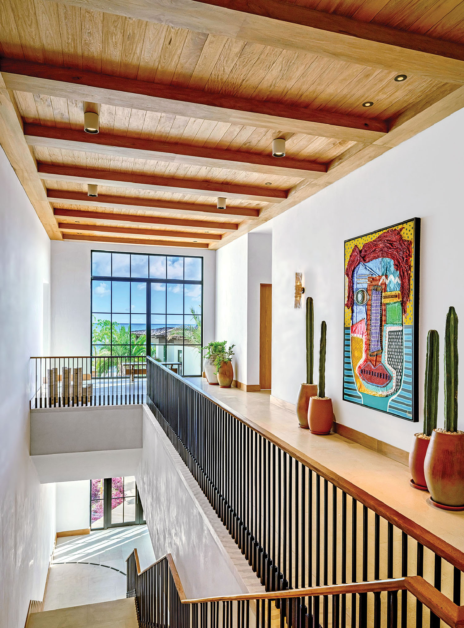 A staircase with a painting on the wall
