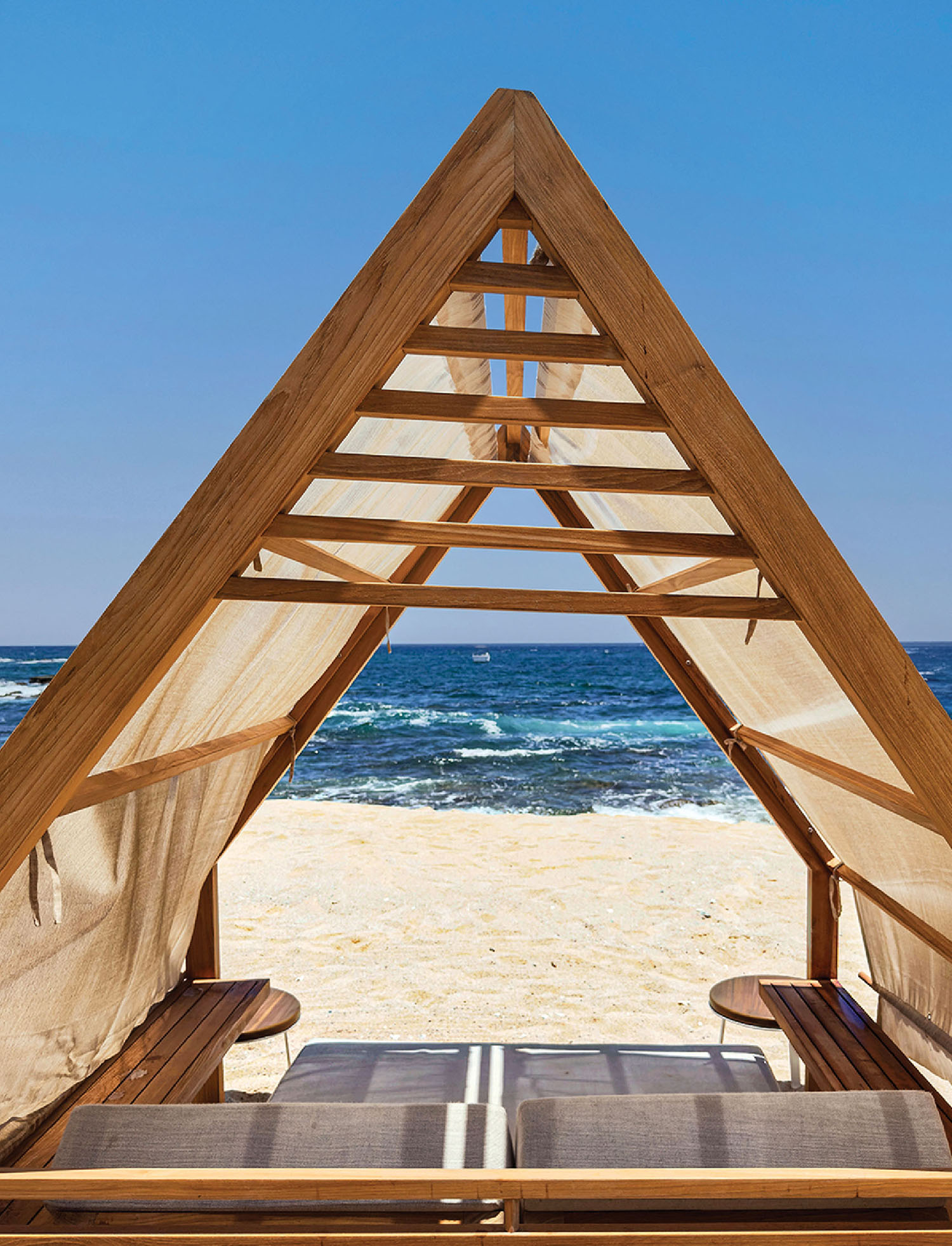 A wooden beach chair on the beach